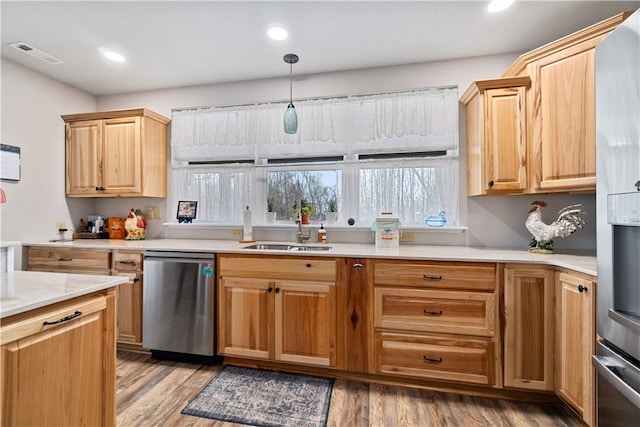 kitchen with light countertops, visible vents, stainless steel appliances, a sink, and light wood-type flooring