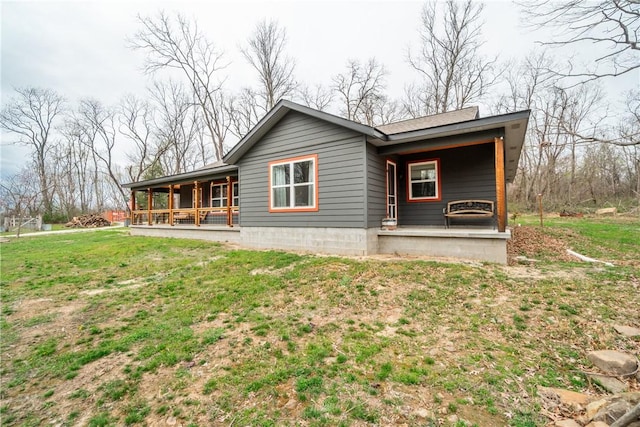 view of home's exterior featuring covered porch and a lawn