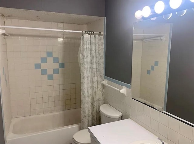 full bath with shower / bath combination with curtain, toilet, vanity, and tile walls