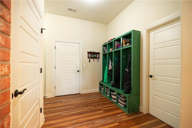 mudroom with baseboards, dark wood finished floors, and visible vents