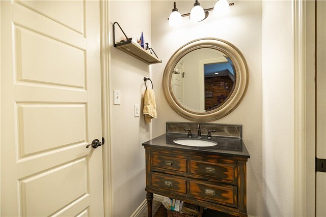 bathroom featuring baseboards and vanity