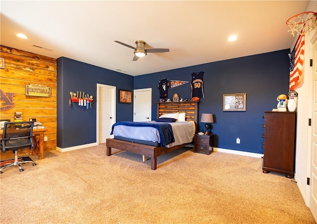 bedroom with carpet flooring, baseboards, ceiling fan, and an accent wall