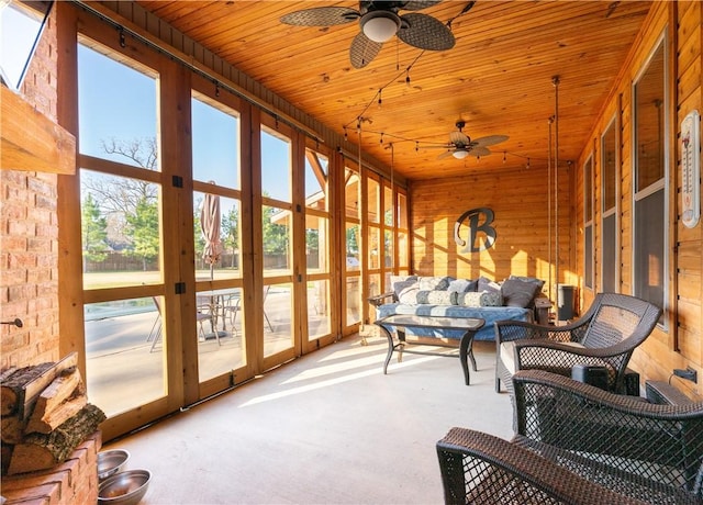 sunroom featuring ceiling fan