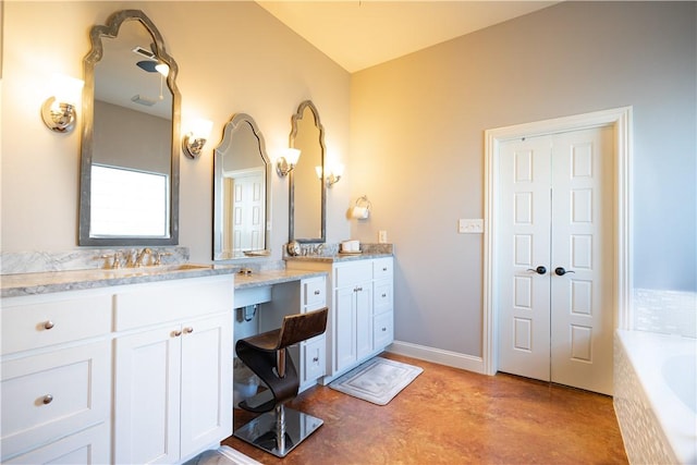 full bathroom featuring baseboards, vanity, concrete flooring, and a washtub