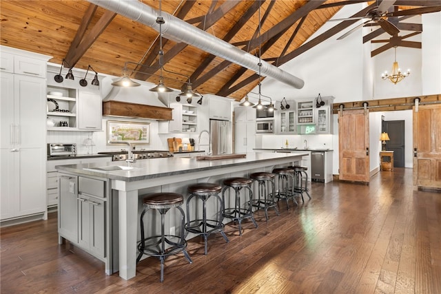 617 N Fallin Ave, Fayetteville, AR 72701 - kitchen featuring dark countertops, stainless steel appliances, a spacious island, and open shelves