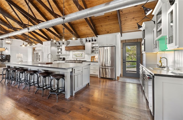 617 N Fallin Ave, Fayetteville, AR 72701 - kitchen featuring custom exhaust hood, stainless steel appliances, dark countertops, dark wood-type flooring, and open shelves