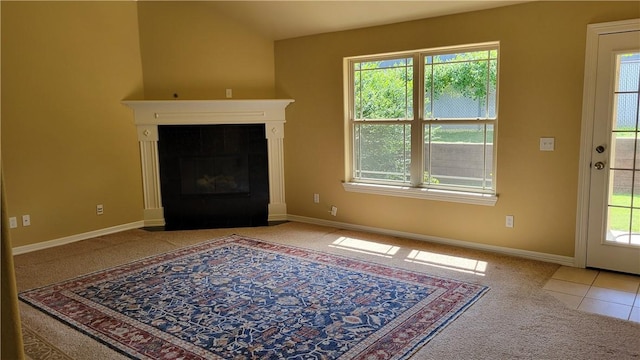 3210 S 3rd St, Rogers, AR 72758 - living room with carpet, a tiled fireplace, and tile patterned flooring