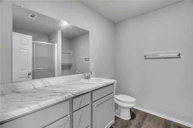 1405 Corsac St, Siloam Springs, AR 72761 - bathroom with wood finished floors, vanity, toilet, a shower stall, and baseboards