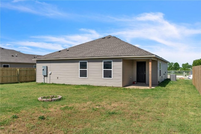 1405 Corsac St, Siloam Springs, AR 72761 - rear view of property with a shingled roof and an outdoor fire pit