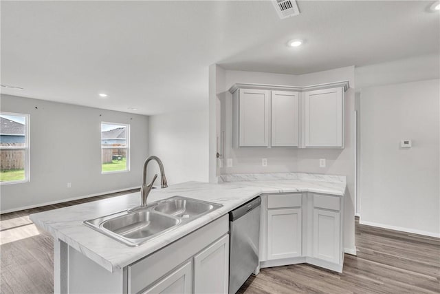 1405 Corsac St, Siloam Springs, AR 72761 - kitchen featuring dishwasher, a sink, a peninsula, light countertops, and light wood finished floors