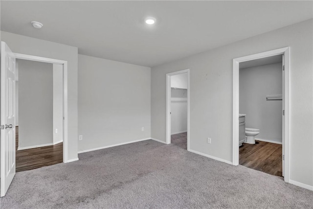 1405 Corsac St, Siloam Springs, AR 72761 - unfurnished bedroom featuring carpet, baseboards, connected bathroom, and a spacious closet