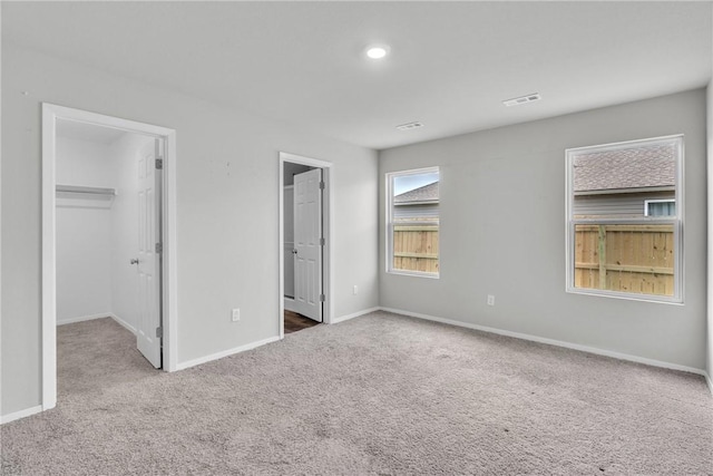 1405 Corsac St, Siloam Springs, AR 72761 - unfurnished bedroom featuring carpet, a spacious closet, baseboards, a closet, and connected bathroom