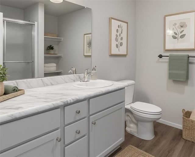 1405 Corsac St, Siloam Springs, AR 72761 - bathroom featuring wood finished floors, vanity, toilet, a shower stall, and baseboards
