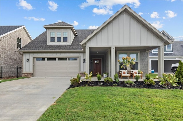 4385 W Huron Loop, Fayetteville, AR 72704 - view of front of house with board and batten siding, a shingled roof, driveway, and a front lawn