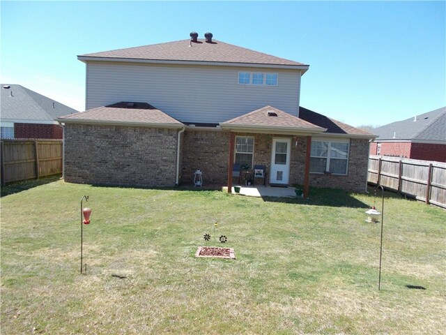 6527 Huntington Ct, Fort Smith, AR 72916 - back of property featuring a lawn, brick siding, and a fenced backyard