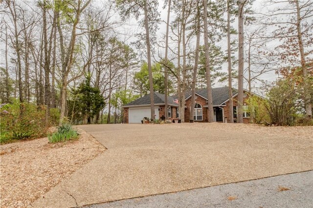 44 Devizis Dr, Bella Vista, AR 72714 - ranch-style home featuring an attached garage, asphalt driveway, brick siding, and roof with shingles