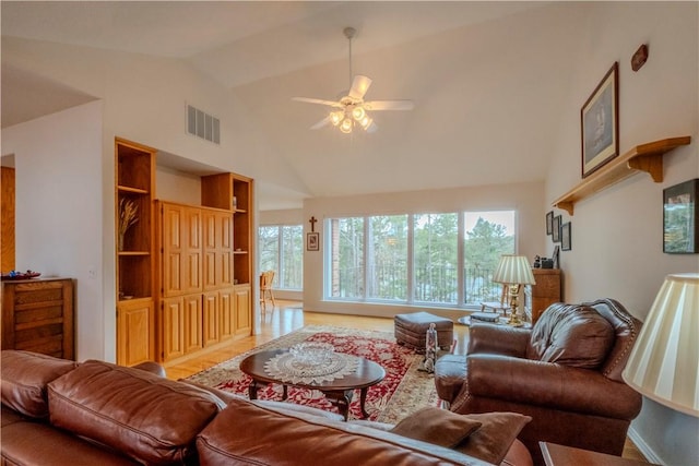 44 Devizis Dr, Bella Vista, AR 72714 - living room with high vaulted ceiling, a ceiling fan, and wood finished floors