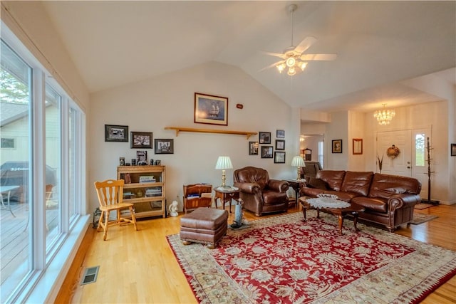 44 Devizis Dr, Bella Vista, AR 72714 - living room with light wood finished floors, lofted ceiling, a chandelier, and ceiling fan