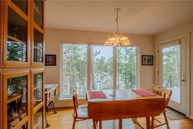 44 Devizis Dr, Bella Vista, AR 72714 - dining area featuring a chandelier, light wood-style flooring, and baseboards