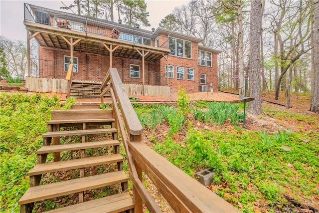 44 Devizis Dr, Bella Vista, AR 72714 - view of front of house featuring stairs, brick siding, and a wooden deck