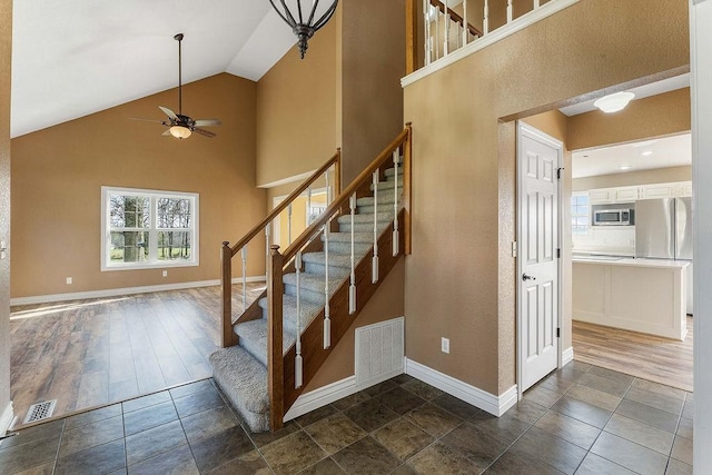 188 Lonestar Rd, Anderson, MO 64831 - stairs featuring a ceiling fan, baseboards, and high vaulted ceiling