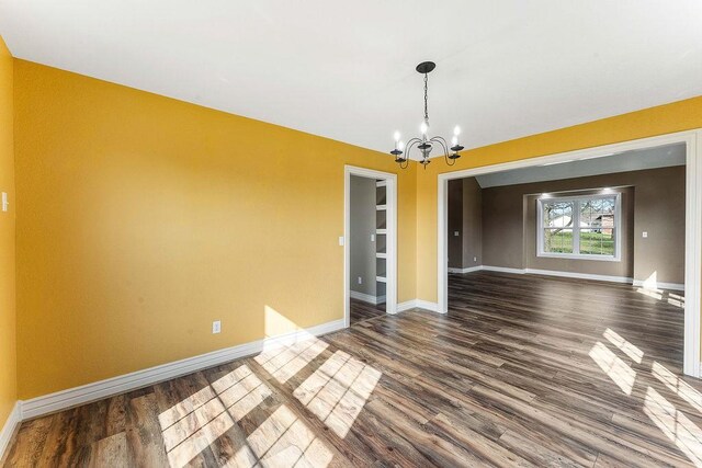 188 Lonestar Rd, Anderson, MO 64831 - spare room with a chandelier, dark wood-style flooring, and baseboards