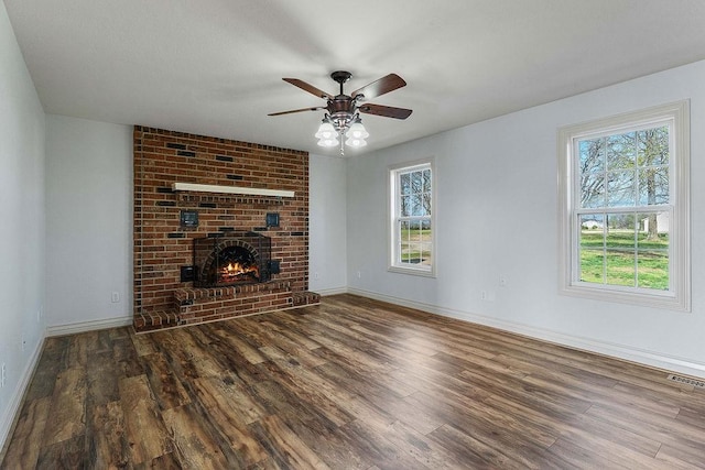188 Lonestar Rd, Anderson, MO 64831 - unfurnished living room with wood finished floors, a ceiling fan, baseboards, and a fireplace