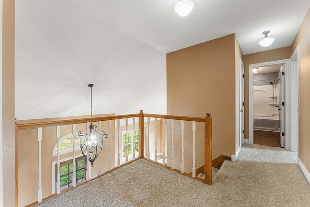 188 Lonestar Rd, Anderson, MO 64831 - corridor with carpet, a chandelier, an upstairs landing, and baseboards