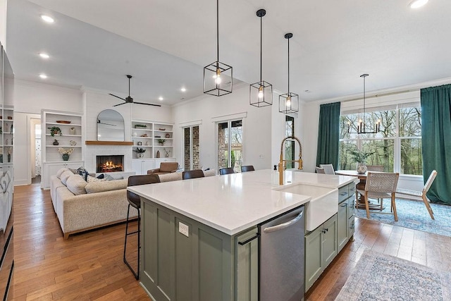 kitchen with a sink, dishwasher, gray cabinetry, and a wealth of natural light