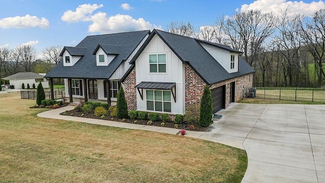 modern inspired farmhouse featuring a front yard, central AC unit, board and batten siding, fence, and driveway