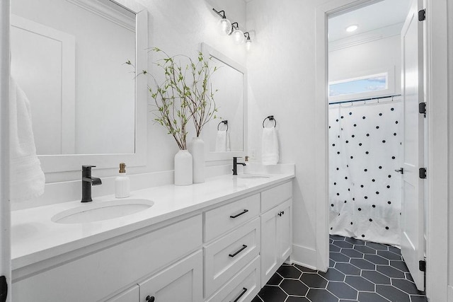 bathroom with a shower with shower curtain, tile patterned flooring, double vanity, and a sink