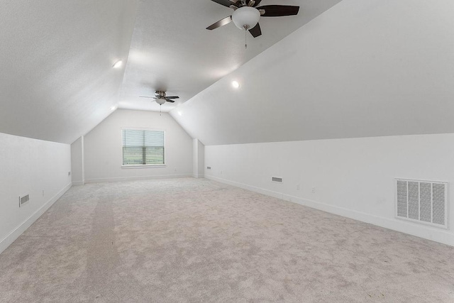 additional living space featuring carpet flooring, ceiling fan, vaulted ceiling, and visible vents