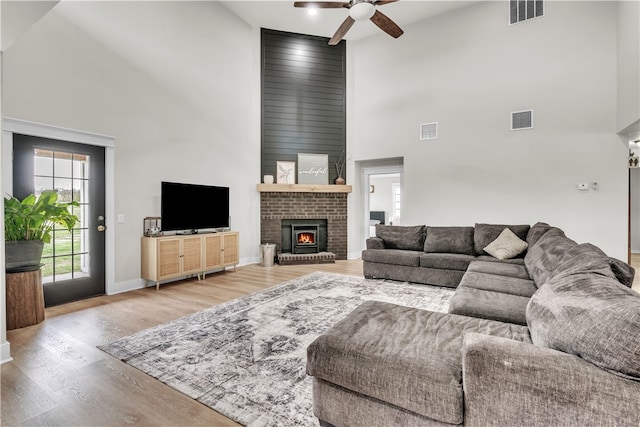 17225 Featherstone Trl, Gentry, AR 72734 - living area featuring visible vents, a high ceiling, light wood-style floors, and a ceiling fan