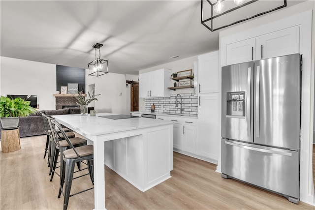 17225 Featherstone Trl, Gentry, AR 72734 - kitchen featuring white cabinetry, stainless steel refrigerator with ice dispenser, light wood finished floors, and open shelves