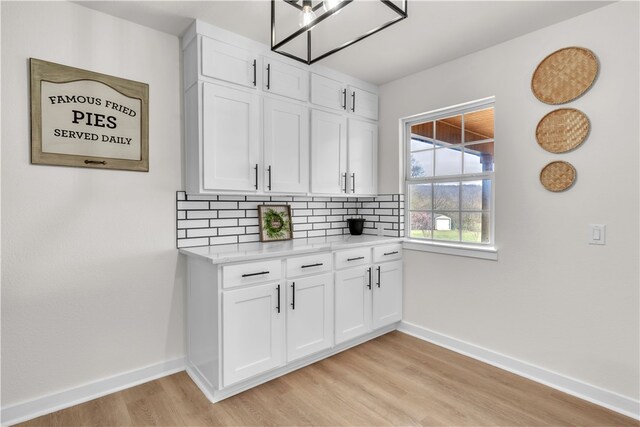 17225 Featherstone Trl, Gentry, AR 72734 - kitchen with light countertops, baseboards, backsplash, light wood finished floors, and white cabinets