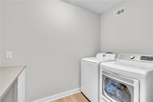 17225 Featherstone Trl, Gentry, AR 72734 - laundry room with light wood-type flooring, baseboards, washer and dryer, and visible vents