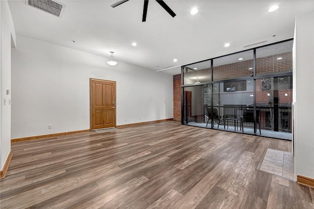 321 E Lafayette St Unit 103, Fayetteville, AR 72701 - spare room featuring baseboards, wood finished floors, ceiling fan, and recessed lighting