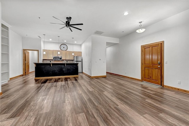321 E Lafayette St Unit 103, Fayetteville, AR 72701 - living area featuring a ceiling fan, wood finished floors, baseboards, recessed lighting, and built in features