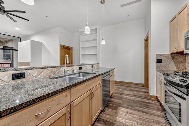 321 E Lafayette St Unit 103, Fayetteville, AR 72701 - kitchen with appliances with stainless steel finishes, a sink, backsplash, dark wood-style flooring, and a ceiling fan