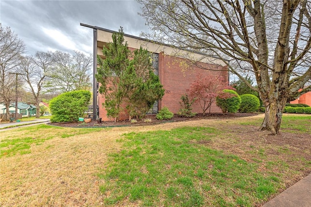 321 E Lafayette St Unit 103, Fayetteville, AR 72701 - view of property exterior featuring a lawn and brick siding