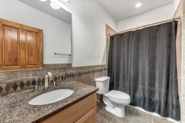 321 E Lafayette St Unit 103, Fayetteville, AR 72701 - full bathroom featuring toilet, vanity, tile patterned floors, tile walls, and curtained shower