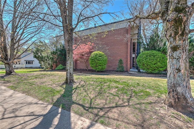 321 E Lafayette St Unit 103, Fayetteville, AR 72701 - view of side of property with brick siding and a yard