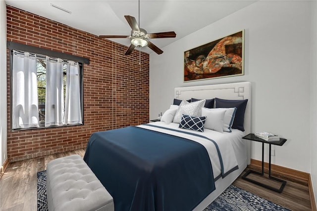 321 E Lafayette St Unit 103, Fayetteville, AR 72701 - bedroom with brick wall, baseboards, wood finished floors, and ceiling fan