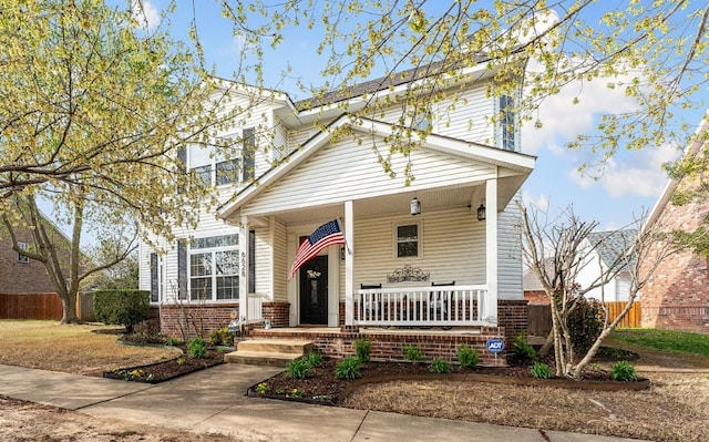6628 Bernice Ave, Springdale, AR 72762 - traditional-style house with a porch and brick siding