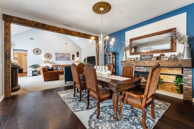 6628 Bernice Ave, Springdale, AR 72762 - dining room with wood-type flooring, a chandelier, baseboards, and a brick fireplace