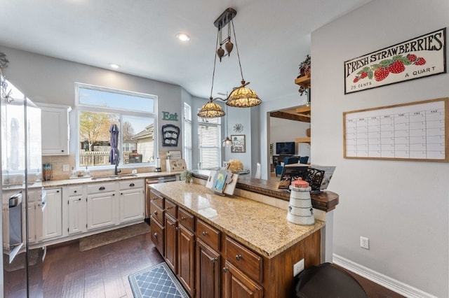 6628 Bernice Ave, Springdale, AR 72762 - kitchen with stainless steel dishwasher, white cabinetry, a sink, light stone countertops, and dark wood finished floors