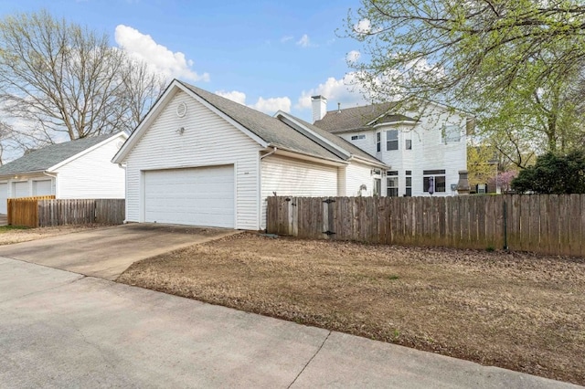 6628 Bernice Ave, Springdale, AR 72762 - view of property exterior with an attached garage, concrete driveway, a chimney, and a shingled roof