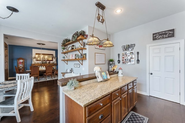 6628 Bernice Ave, Springdale, AR 72762 - kitchen with light stone countertops, dark wood finished floors, a chandelier, and decorative light fixtures