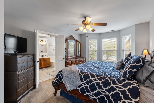 6628 Bernice Ave, Springdale, AR 72762 - bedroom featuring light tile patterned floors, light carpet, ensuite bathroom, ceiling fan, and a sink