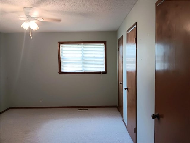 1003 Freeman Ave, Berryville, AR 72616 - spare room featuring ceiling fan, a textured ceiling, light carpet, and baseboards